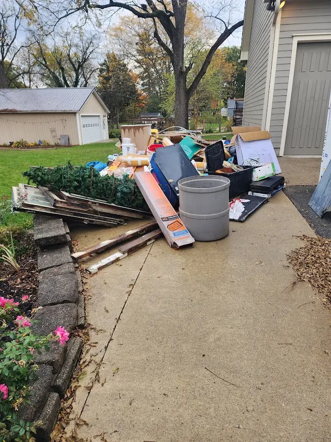 Dumpster being loaded with debris for Roofing Dumpster Rental in Pearland